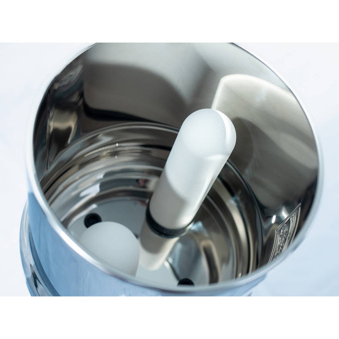 Close-up of the polished stainless steel interior of a gravity water filter showing the cylindrical ceramic filter elements designed for effective purification in camping, emergency, farm, and garden settings.