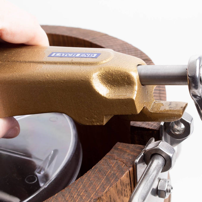 Close-up of a handcrafted wooden ice cream freezer latch with sturdy metal clamp and a textured gold crank handle, showcasing exclusive rugged design for Kitchen & Food and Specialty Equipment collections.