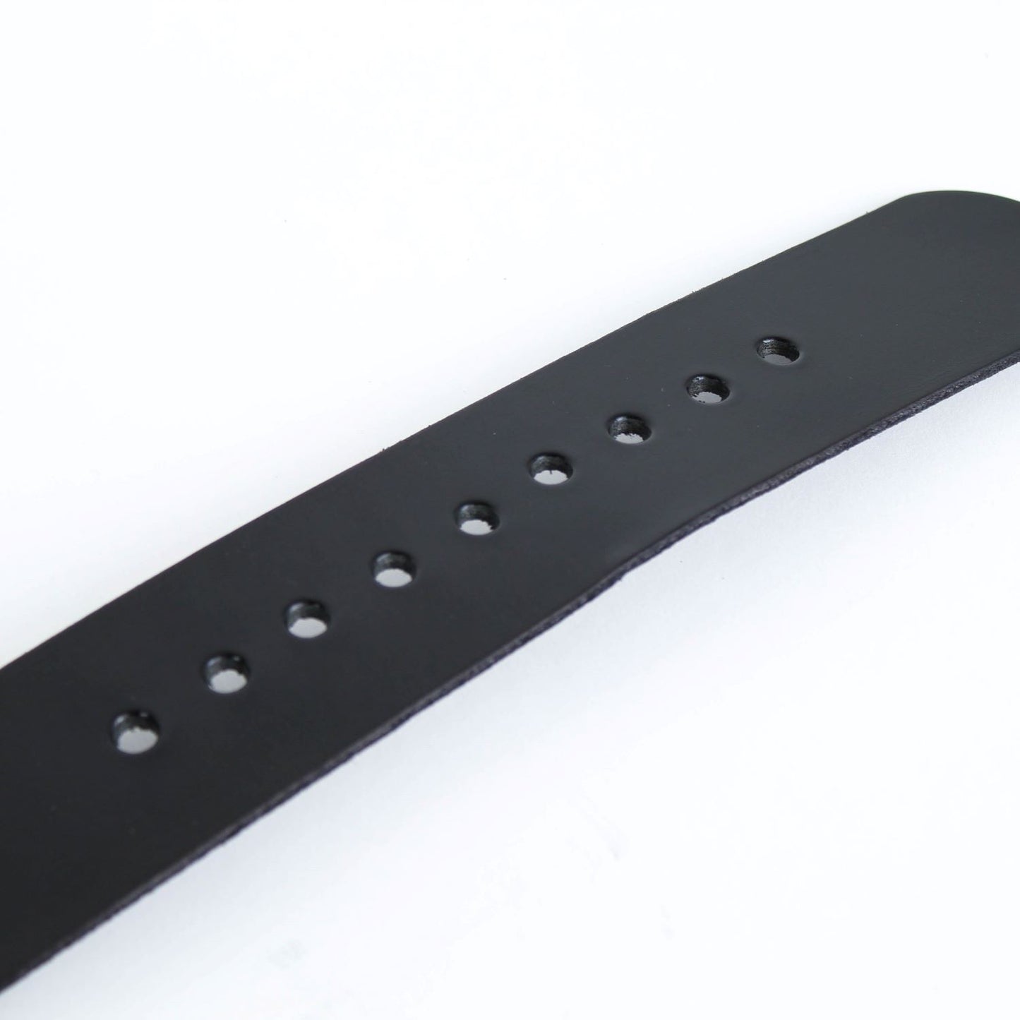 Close-up of a smooth black genuine cowhide leather belt strap with evenly spaced adjustment holes, handcrafted in the USA, featured in Health & Wellness, Amish Made, and Best Sellers collections.