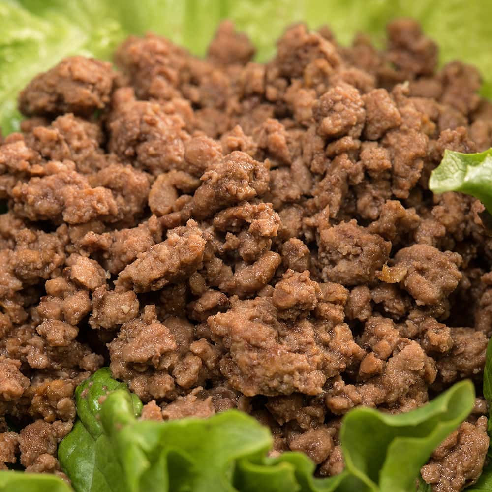Close-up of handcrafted cooked ground beef nestled on fresh green lettuce, showcasing natural quality for quick meals, featured in Kitchen & Food, Food, Meats, Best Sellers, and Promo Eligible collections.