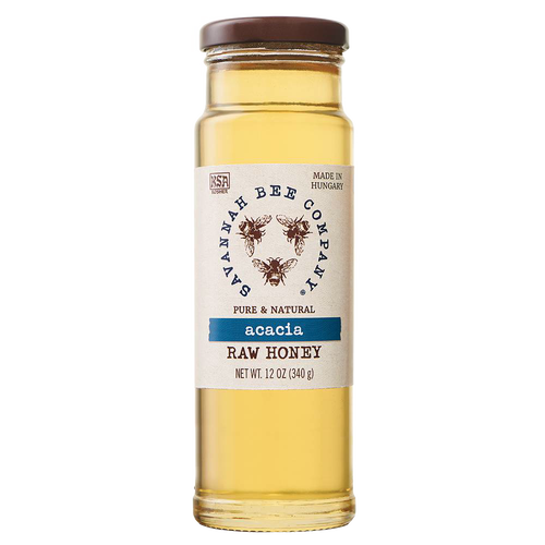 Clear glass jar of pale golden acacia raw honey with a brown lid and natural label featuring bees, ideal for Pantry and Kitchen & Food collections in Best Sellers and Sale.
