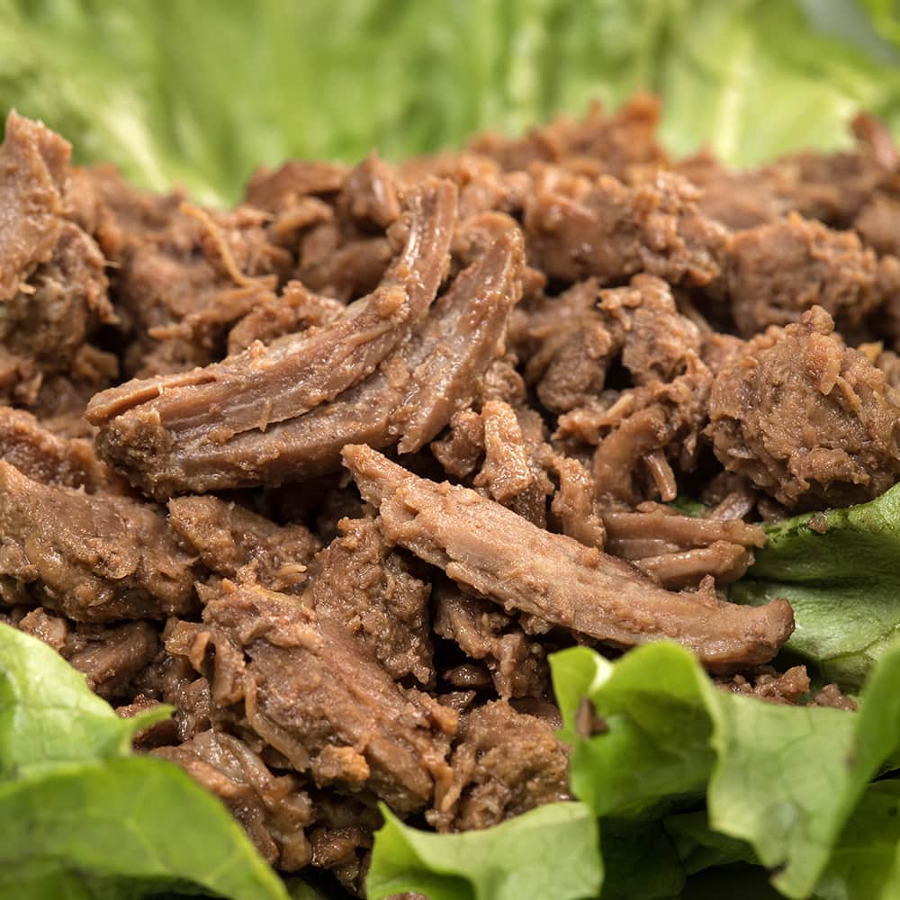 Close-up of shredded canned beef served on fresh green lettuce, showcasing handcrafted emergency food ideal for Farm, Garden & Tool, Kitchen & Food, and Best Sellers collections.