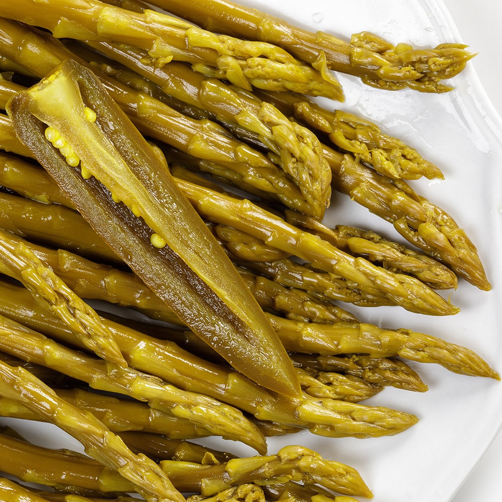 Close-up of handcrafted pickled asparagus spears with a sliced jalapeno pepper, highlighting tangy, spicy flavor and Amish-made quality, perfect for Kitchen & Food, Pantry, and USA Made collections.