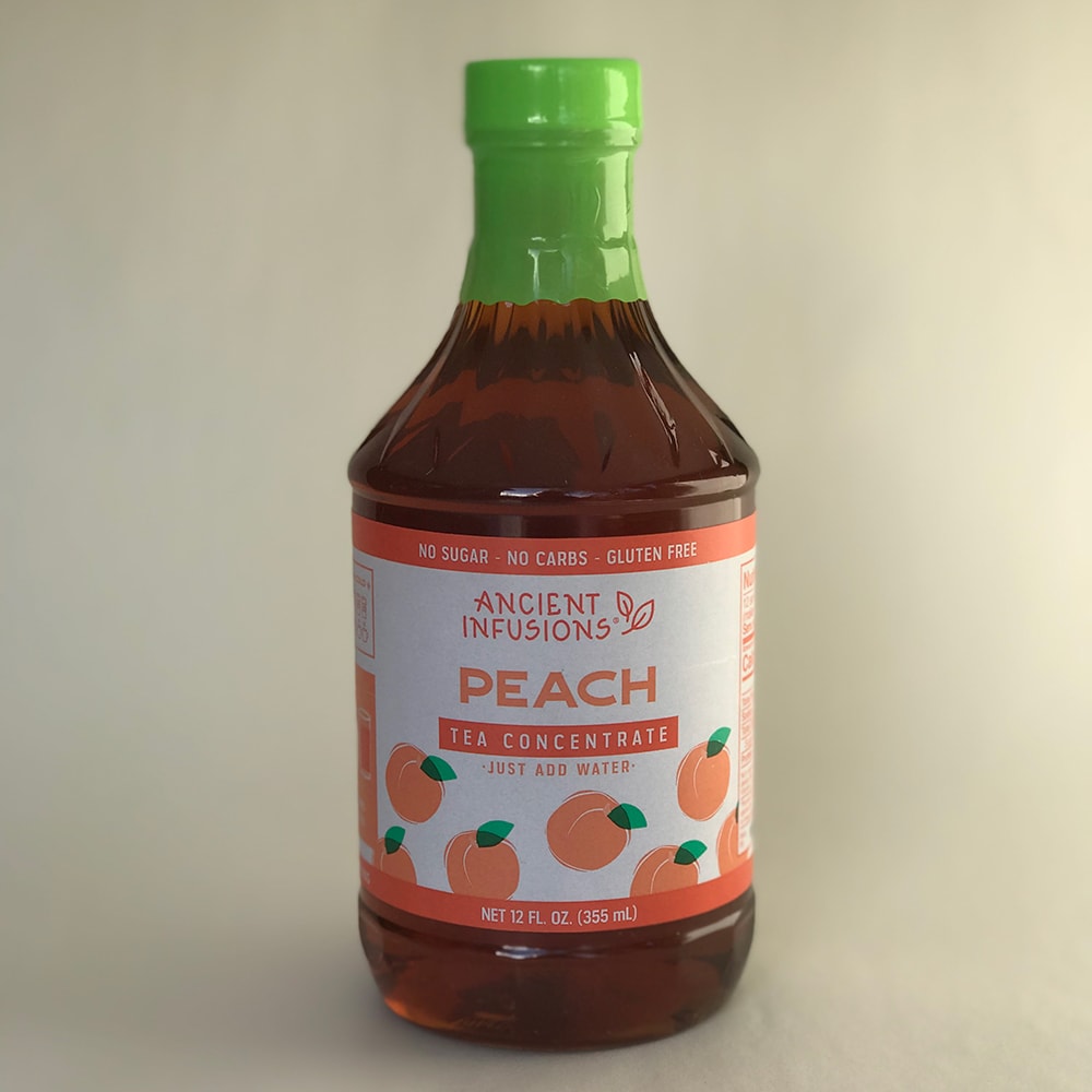 Bottle of handcrafted peach tea concentrate with bright green cap and label featuring peach illustrations, made in USA, ideal for Kitchen & Food, Beverages, and Best Sellers collections.