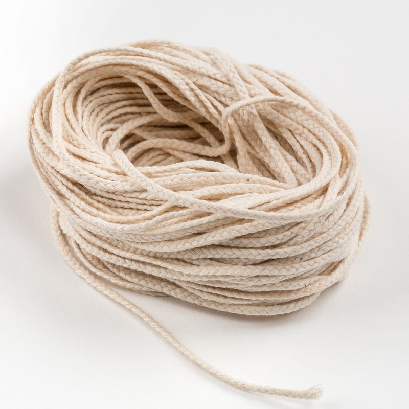 Coiled natural 30-ply flat-braid wick strands for crafting pillar or taper candles from 2 to 4 inches, featured in Lamps & Lighting, Candles and Candlemaking, Candlemaking Supplies, Best Sellers, and Promo Eligible collections.