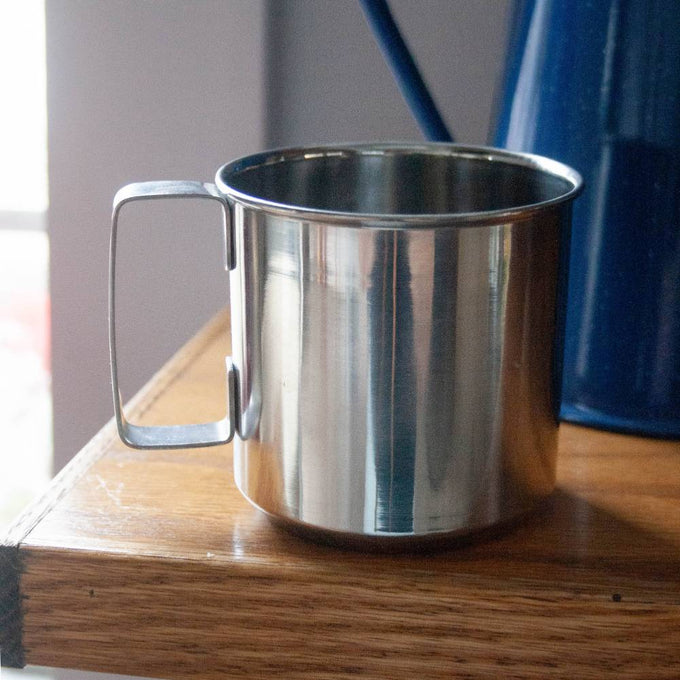 Lightweight stainless steel cup with seamless construction and a convenient handle, ideal for camping or everyday use, featured in Kitchen & Food and Best Sellers collections.