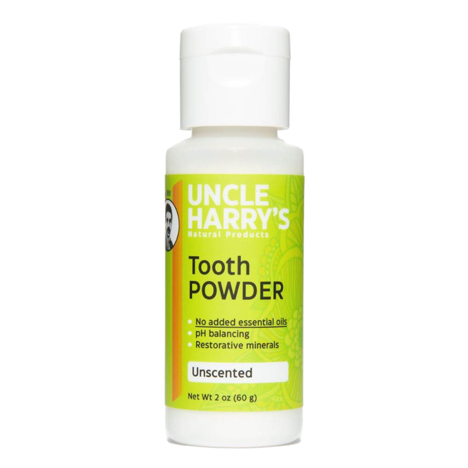 White plastic bottle of natural tooth powder featuring bright green label with product benefits including pH balancing and restorative minerals, handcrafted and made in USA, ideal for Health & Wellness and Grooming collections.