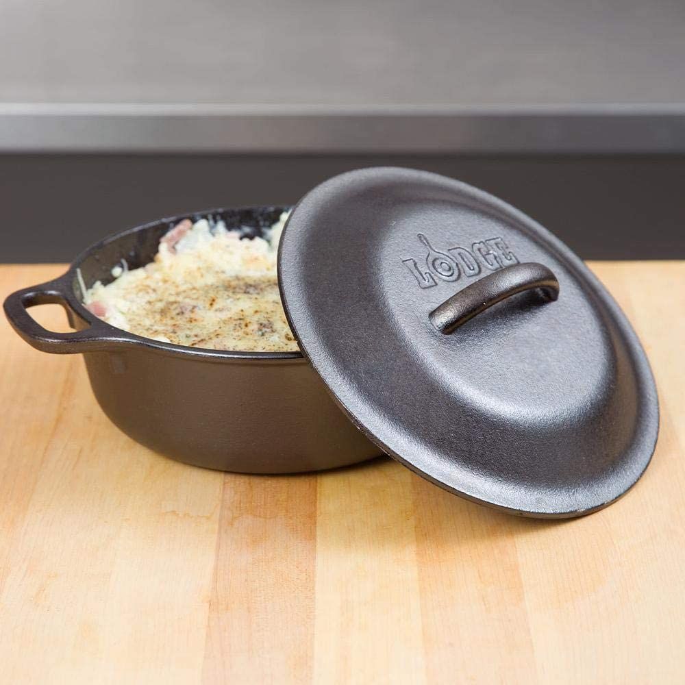 Handcrafted cast iron Dutch oven with embossed lid resting beside baked dish, designed for heat retention and slow-cooked meals, perfect for Kitchen & Food, Cast Iron, USA Made collections.