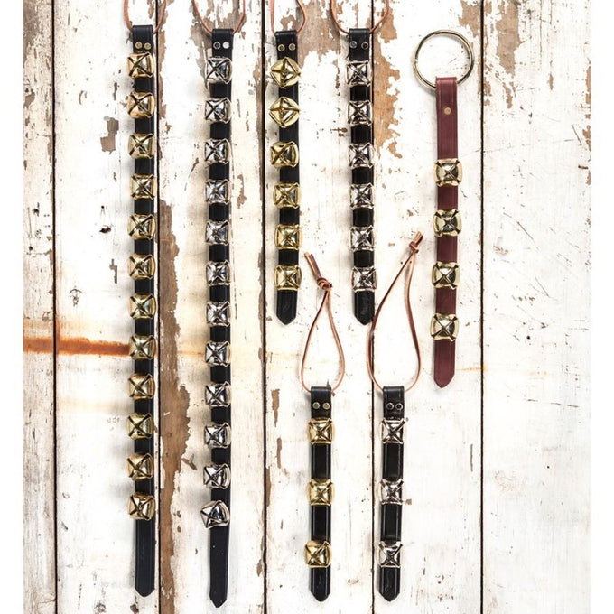 Variety of handcrafted sleigh bell door hangers with brass and silver bells on black and brown leather straps, featuring leather ties, perfect for holiday decor and USA made collections.