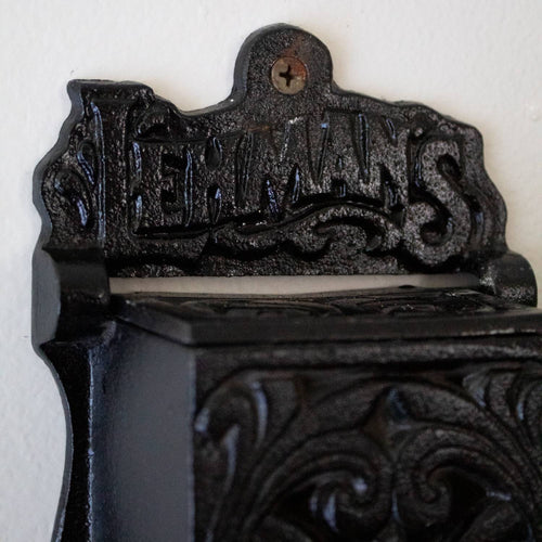 Handcrafted black metal wall-mounted matchbox holder with embossed decorative scrollwork and Lehman's branding, made in USA, ideal for Home & Decor, Household Helpers, and Best Sellers collections.