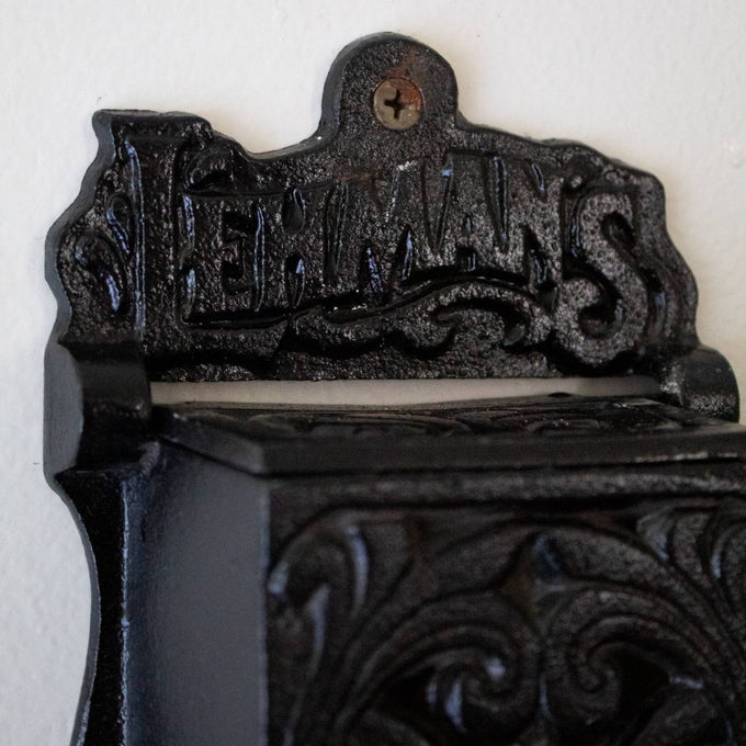 Handcrafted black metal wall-mounted matchbox holder with embossed decorative scrollwork and Lehman's branding, made in USA, ideal for Home & Decor, Household Helpers, and Best Sellers collections.