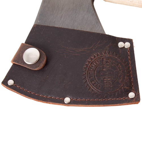 Close-up of a handcrafted high-carbon steel axe blade partially covered by a dark brown leather sheath embossed with a circular logo and secured with metal rivets, featuring Amish made craftsmanship from USA made wood cutting and hauling tools collections.