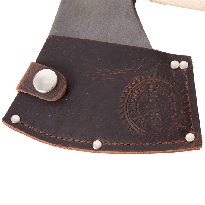 Close-up of a handcrafted high-carbon steel axe blade partially covered by a dark brown leather sheath embossed with a circular logo and secured with metal rivets, featuring Amish made craftsmanship from USA made wood cutting and hauling tools collections.