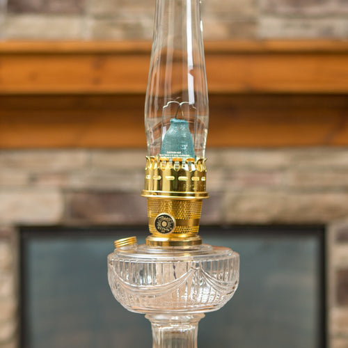 Glass oil lamp with clear base, brass burner, and bright blue flame mantle, part of Lamps & Lighting, Parts and Accessories, Wicks and Mantles, Lamp Burners and Collars, Best Sellers, and Promo Eligible collections.