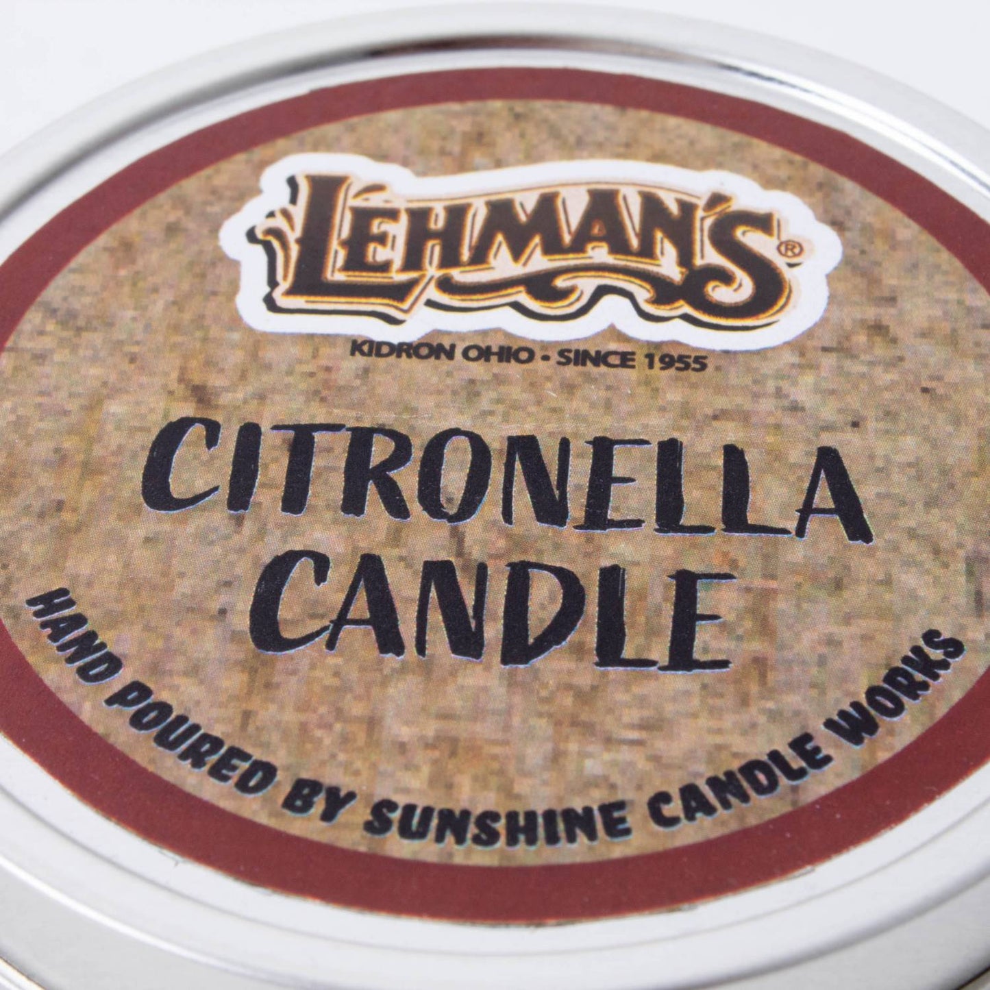 Close-up of a hand-poured citronella candle tin lid featuring Lehman's branding, crafted for outdoor use in camping, pest control, and garden lighting collections.
