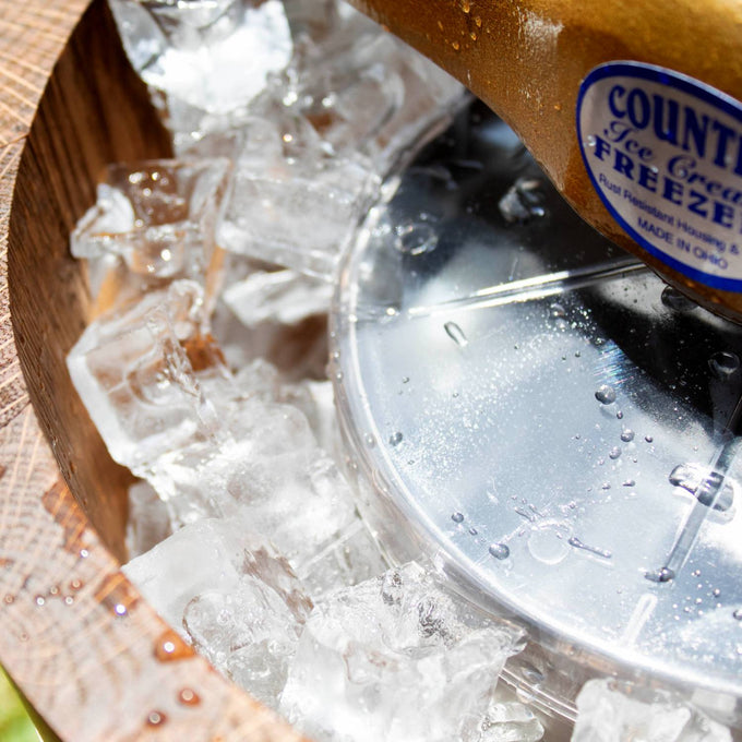 Close-up of handcrafted Amish made wooden ice cream freezer filled with ice, showcasing the durable metal mixing paddle and rustic design for Kitchen & Food and Specialty Equipment collections.