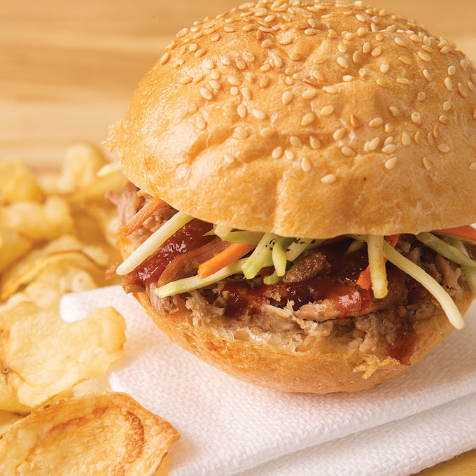 Handcrafted pulled pork sandwich with barbecue sauce and fresh coleslaw on a sesame seed bun, served with crispy potato chips, perfect for Farm, Garden & Tool, Kitchen & Food, Emergency Supplies, Food, Meats, Best Sellers, and Promo Eligible collections.