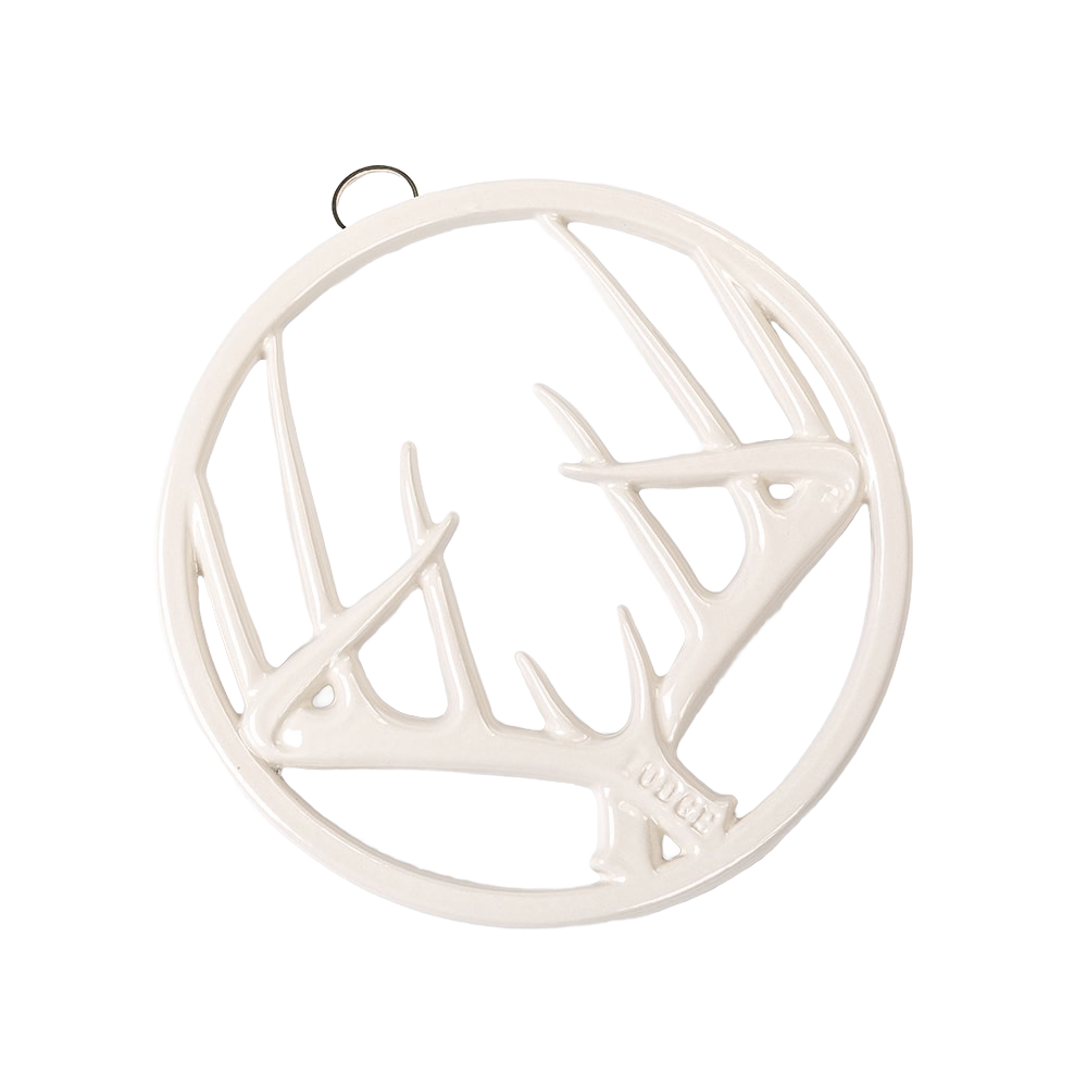 Round enamel trivet in off-white with an antler design, featuring a built-in hanger and rubber feet, perfect for Kitchen & Food, Dinnerware, Storage and Serving, Best Sellers, and Promo Eligible collections.