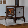 Traditional style Hearthstone Castleton 1 wood heat stove with cast iron frame and stone panels, burning warmly on a polished marble hearth indoors, ideal for Stoves and Best Sellers collections.