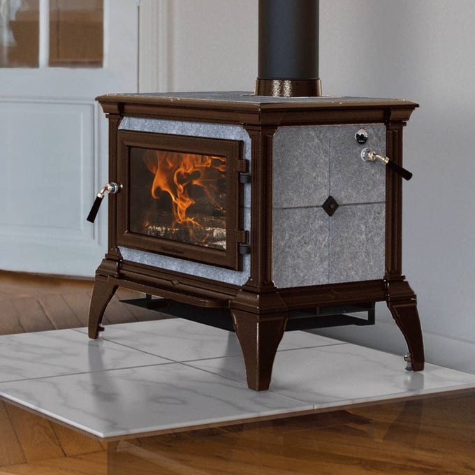Traditional style Hearthstone Castleton 1 wood heat stove with cast iron frame and stone panels, burning warmly on a polished marble hearth indoors, ideal for Stoves and Best Sellers collections.