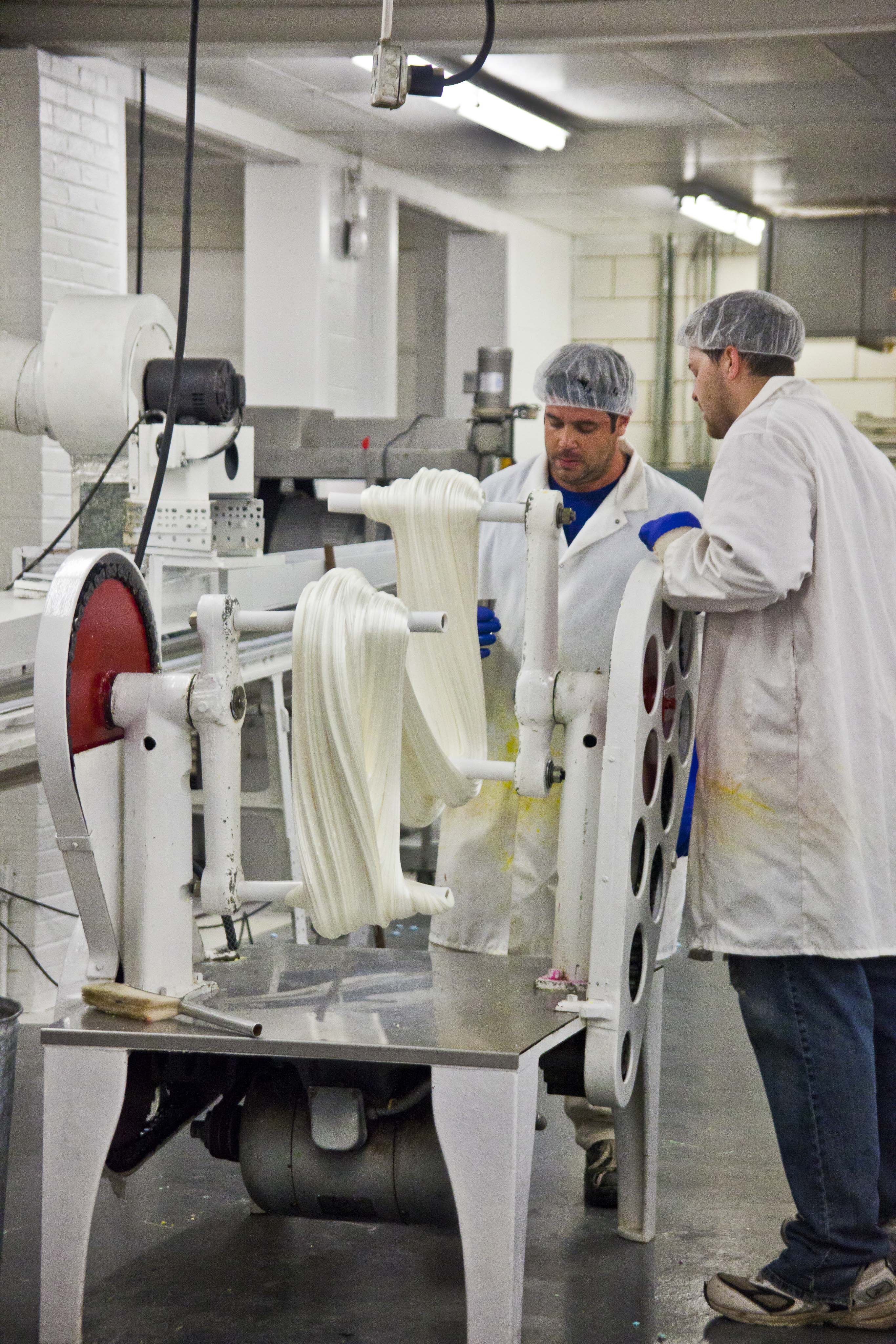 Dauphin and Paul Freeder add flavor while the antique puller cools and whips air into a batch of Sugar Puffs.