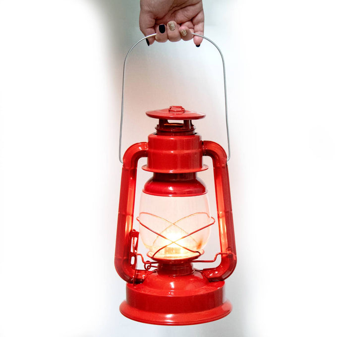 Hand holding a vibrant red handcrafted lantern glowing warmly inside a clear glass globe, featuring a weather-resistant powder-coated finish for reliable outdoor and emergency use in Farm, Garden & Tool, Camping, and Lamps & Lighting collections.