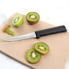 Handcrafted Rada Super Parer with high carbon stainless steel blade and solid black handle, slicing fresh kiwi on a cutting board, ideal for kitchen knives and food prep collections.