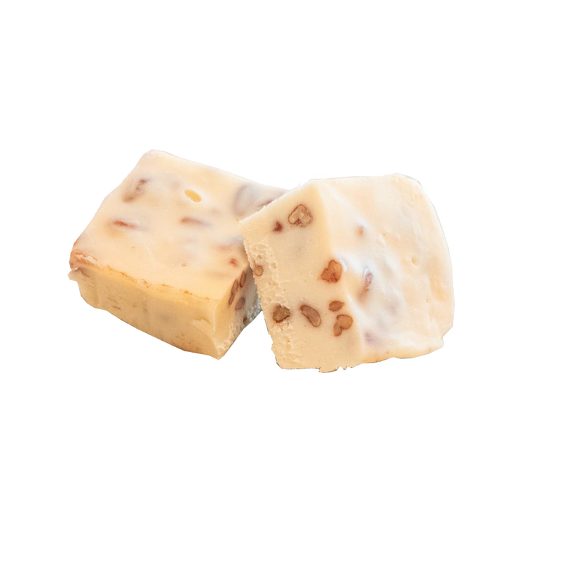 Two handcrafted creamy white fudge squares with embedded walnut pieces, showcasing a smooth, melt-in-your-mouth texture from a unique Amish-made recipe, featured in Kitchen & Food, Snacks and Sweets, USA Made, Best Sellers, Promo Eligible collections.