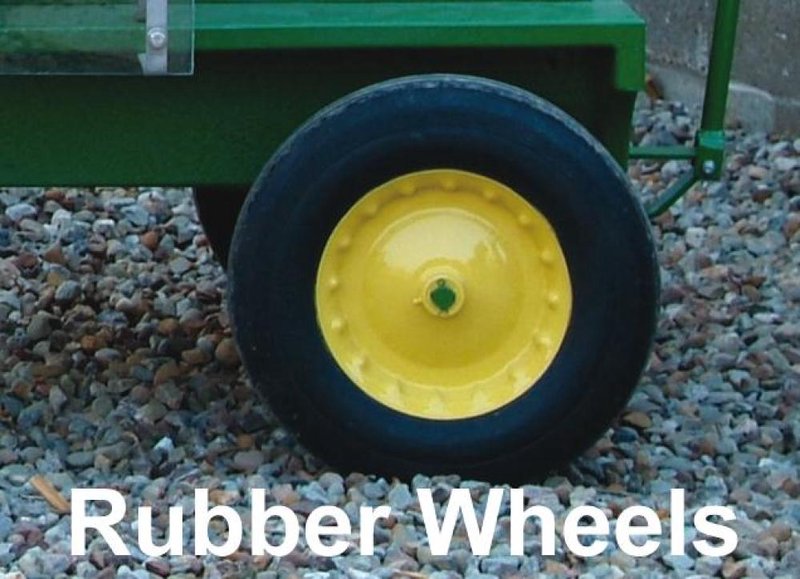 Close-up of a durable solid rubber wheel with bright yellow metal hub mounted on a handcrafted trailer, part of Kitchen & Food, Specialty Equipment, and Making Ice Cream collections.