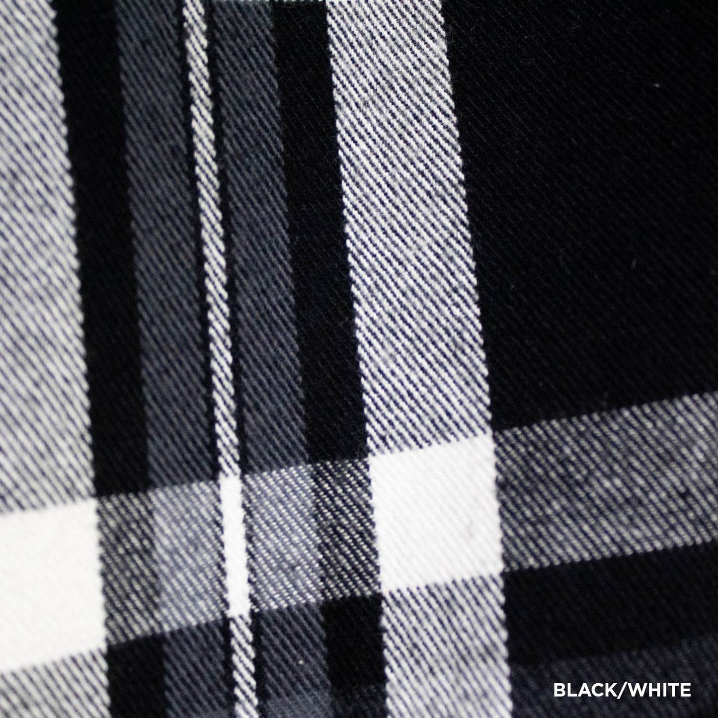 Close-up of handcrafted black and white flannel fabric featuring a classic plaid pattern with detailed woven texture, ideal for clothing and health & wellness collections.