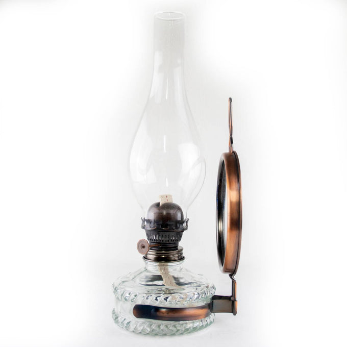Handcrafted reflector oil lamp with clear glass base, removable copper-toned mirror reflector, and tall glass chimney, suitable for Lamps & Lighting, Oil Lamps, Wall Lamps, Best Sellers, Promo Eligible, and Sale collections.