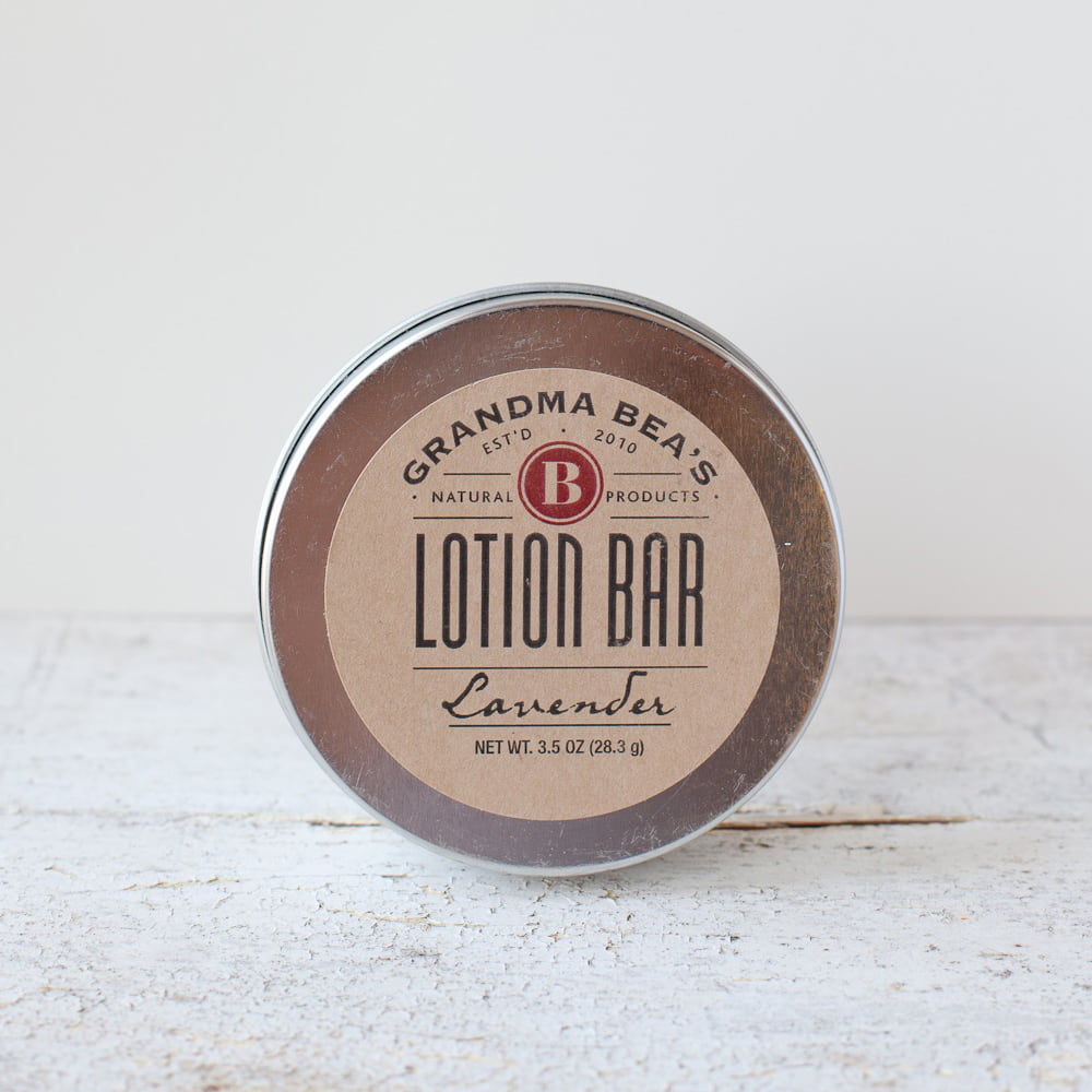 Round all-natural lotion bar tin with lavender scent, handcrafted in the USA, nourishing skin with oils, vitamin E, and beeswax, featured in Health & Wellness, Balms, Creams and Lotions, Grooming and Personal Hygiene, USA Made, Best Sellers, and Promo Eligible collections.