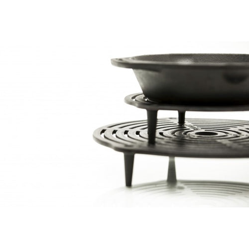 Solid cast iron stack grate with elevated legs supporting a pan above, designed for layered cooking and even heat distribution, suitable for Farm, Garden & Tool, Kitchen & Food, Camping, Cookware, Cast Iron, Best Sellers, and Promo Eligible collections.