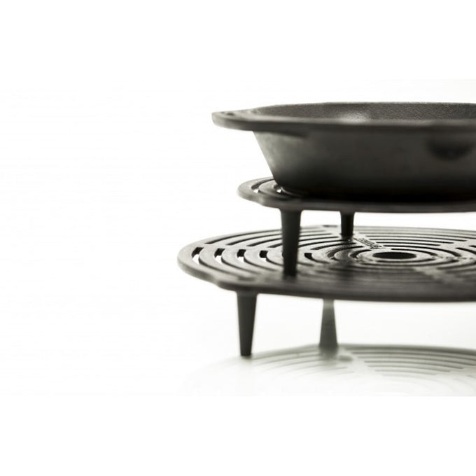 Solid cast iron stack grate with elevated legs supporting a pan above, designed for layered cooking and even heat distribution, suitable for Farm, Garden & Tool, Kitchen & Food, Camping, Cookware, Cast Iron, Best Sellers, and Promo Eligible collections.