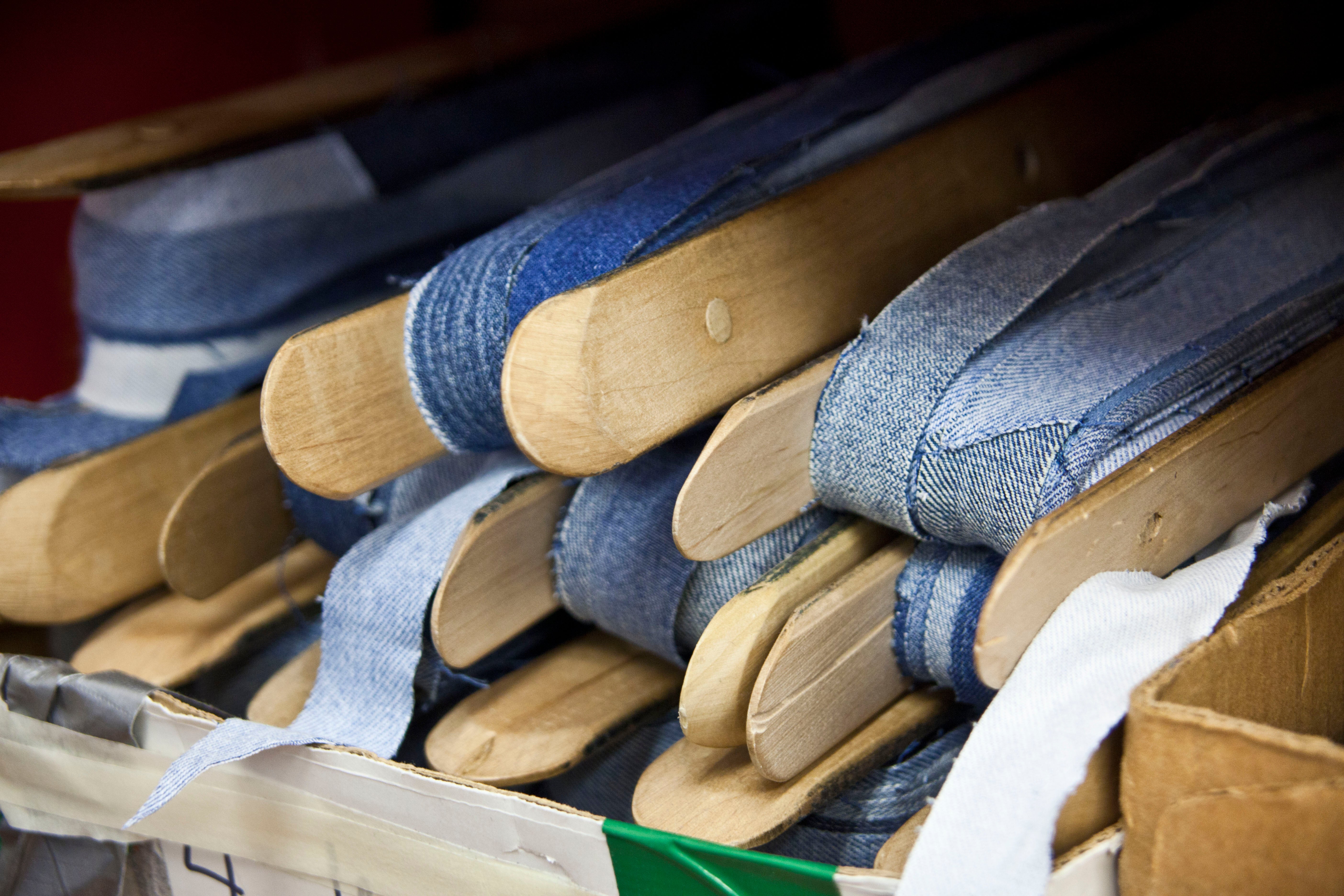 Denim is wound around a shuttle in preparation for the loom.