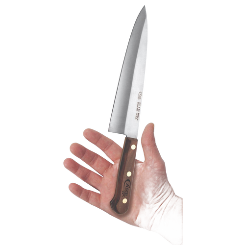 8-inch kitchen knife with polished stainless steel blade and dark wood handle featuring brass rivets, held in hand, ideal for food prep in Kitchen Knives and USA Made collections.
