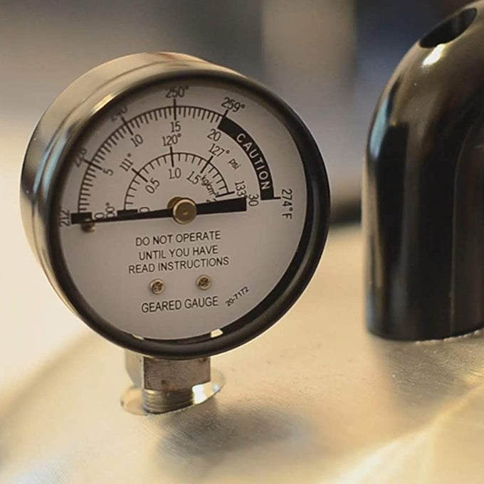 Close-up of a handcrafted pressure gauge displaying temperature and pressure readings on a stainless steel surface, part of Kitchen & Food, Food Preservation, and Pressure Canners collections.