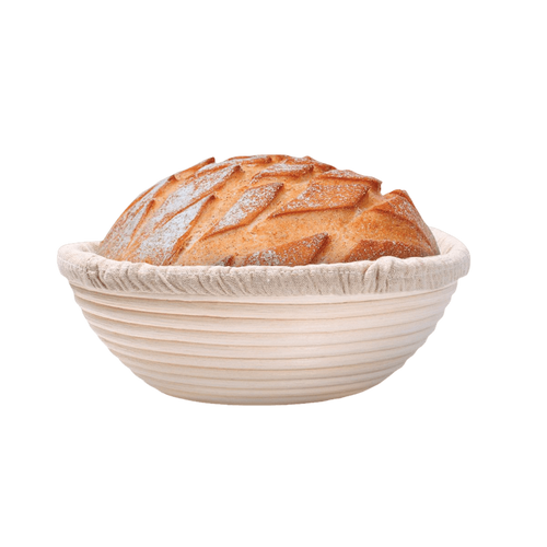 Handcrafted rattan bread proofing basket with a natural removable liner holding a golden artisan loaf, ideal for Kitchen & Food, Baking Supplies, and Bread Making collections.