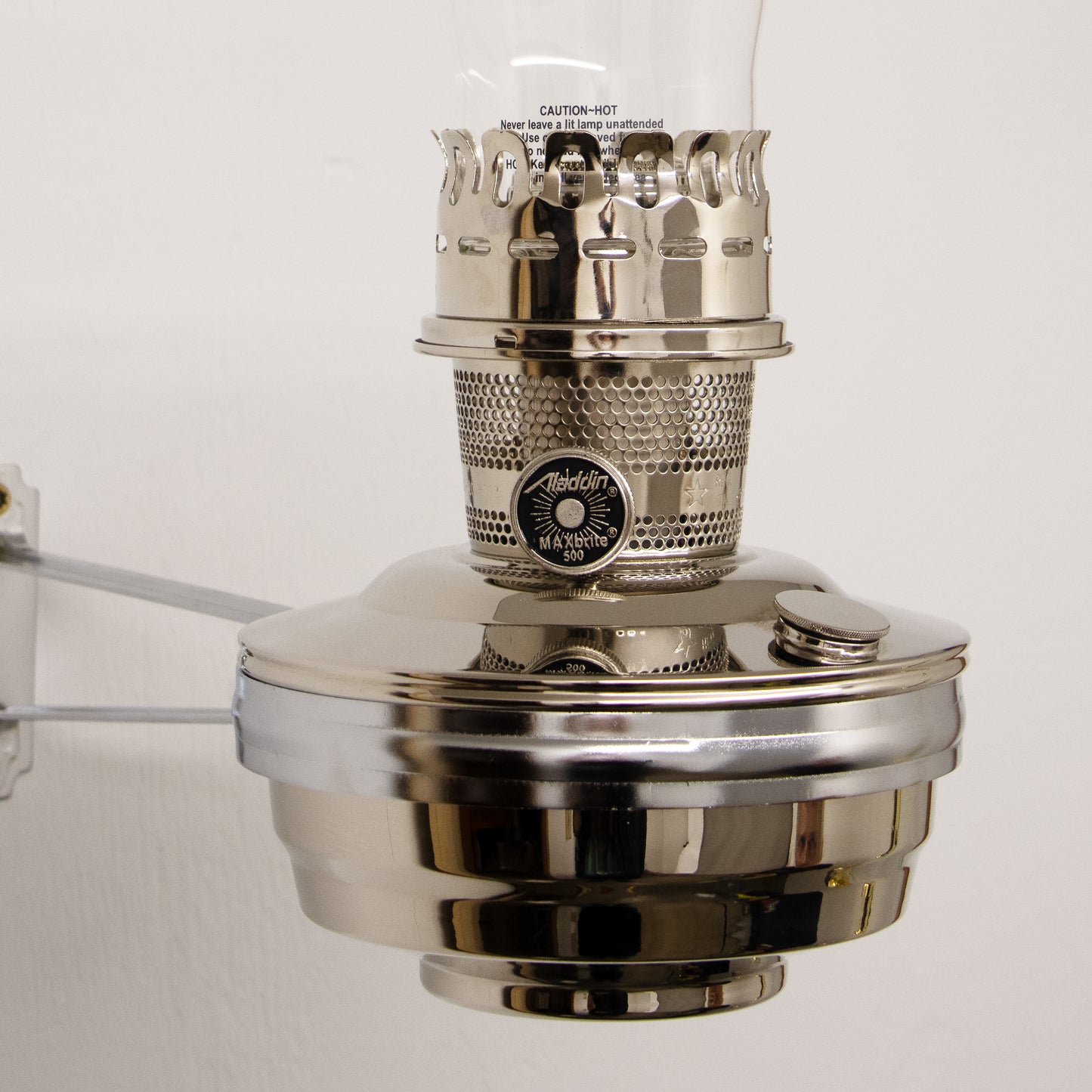 Handcrafted polished metal wall bracket with an 11-3/4-inch arm and 6-inch ring diameter, designed to securely mount classic Aladdin oil lamps, featured in Lamps & Lighting, Oil Lamps, Wall Lamps, Best Sellers, and Promo Eligible collections.