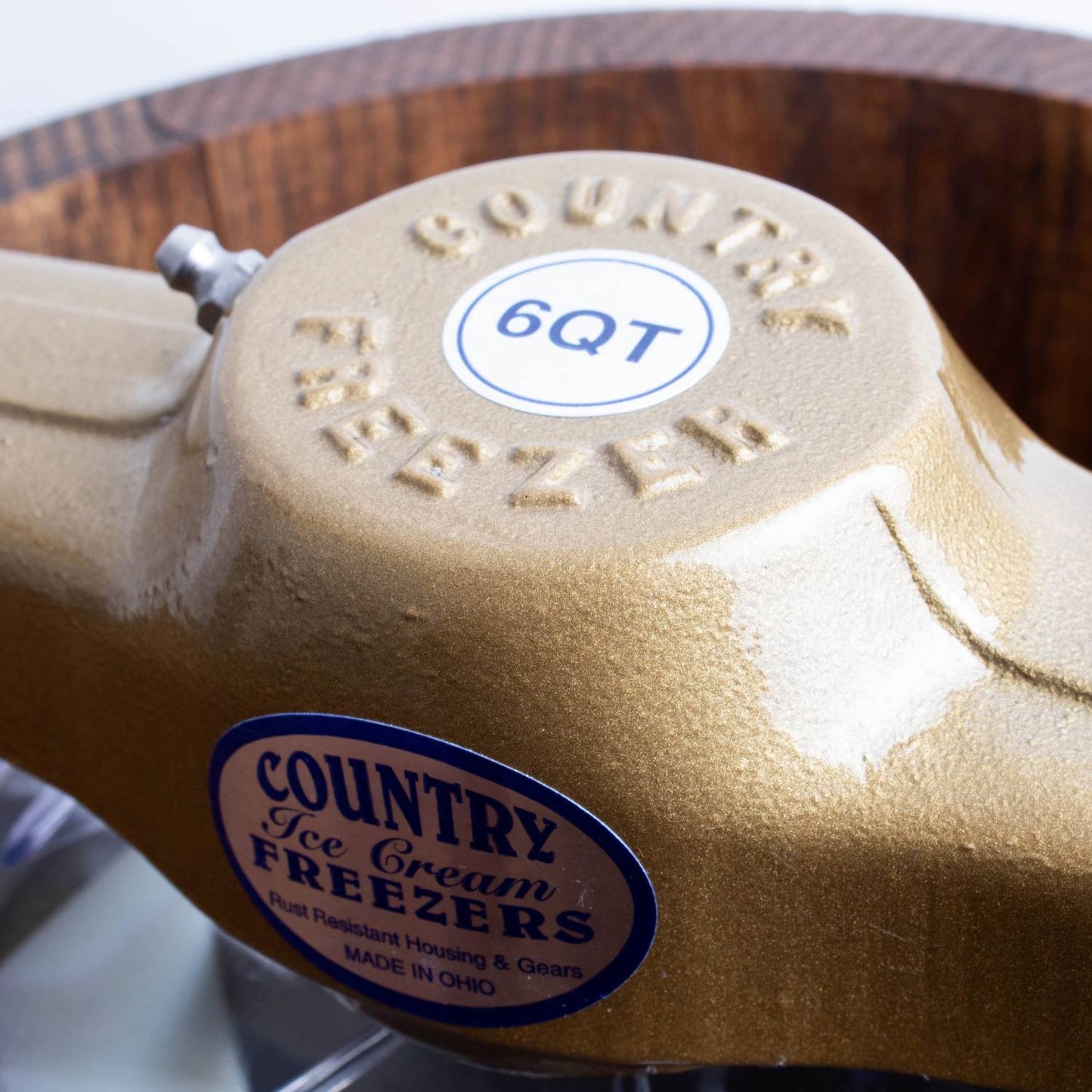 Close-up of a rugged metal crank housing on a handcrafted 6-quart ice cream freezer, part of a unique Amish made collection for Kitchen & Food, Specialty Equipment, and USA Made categories.