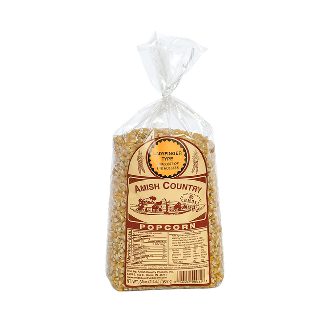 Clear plastic bag filled with small, golden ladyfinger popcorn kernels labeled Amish Country with a vintage-style brown design, featured in Kitchen & Food and Snacks and Sweets collections.