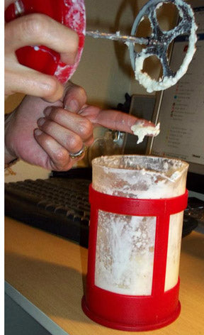 As solids begin to come together, clean off plunger. This is about 10 minutes into process.