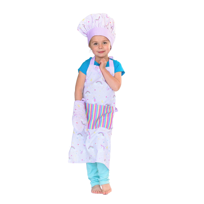 Young child wearing a pastel unicorn-patterned apron, matching chef hat, and oven mitt, standing barefoot against a white background, ideal for Kitchen & Food and Arts and Crafts collections.