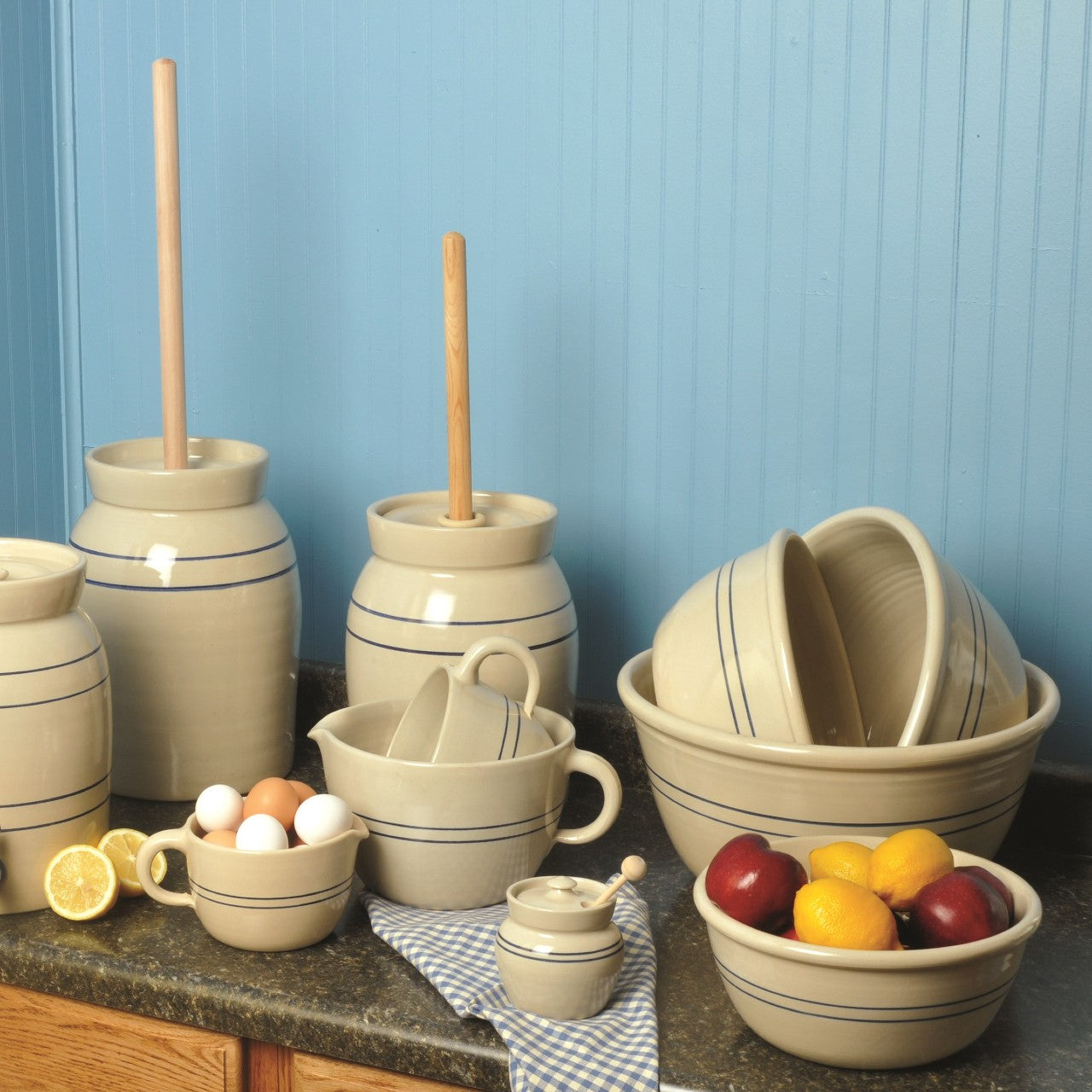 Collection of handcrafted stoneware kitchenware with classic blue stripes, featuring batter bowls, crocks, and utensils, durable and made in USA for Kitchen & Food and Best Sellers collections.