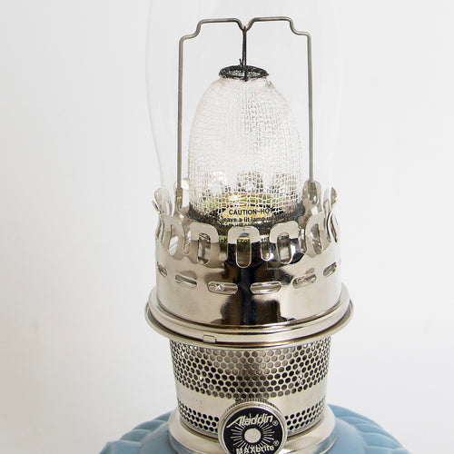 Close-up of a handcrafted limited edition oil lamp burner with polished metal details and clear textured glass chimney, featured in Lamps & Lighting, Oil Lamps, Table Lamps, Best Sellers, and Promo Eligible collections.
