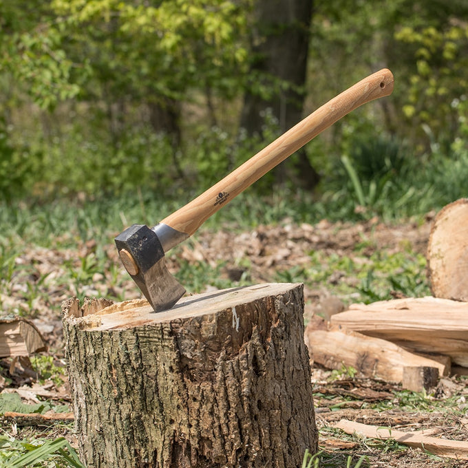 Hand-forged splitting axe with a sharp steel head and smooth wooden handle stuck into a tree stump, handcrafted for durability in Farm, Garden & Tool, Knives & Axes, and Best Sellers collections.