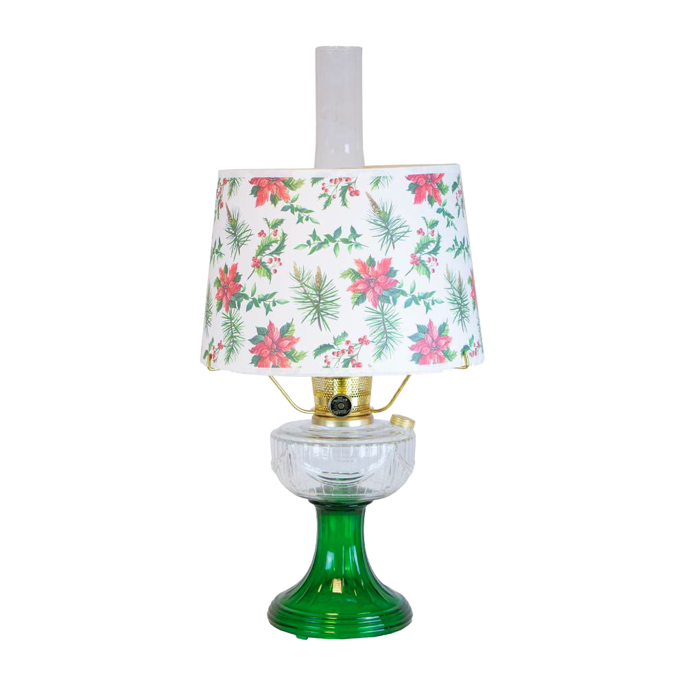 Handcrafted oil lamp with clear over emerald glass base and festive holly and pine patterned lampshade, featured in Lamps & Lighting, Oil Lamps, Table Lamps, and Best Sellers collections.