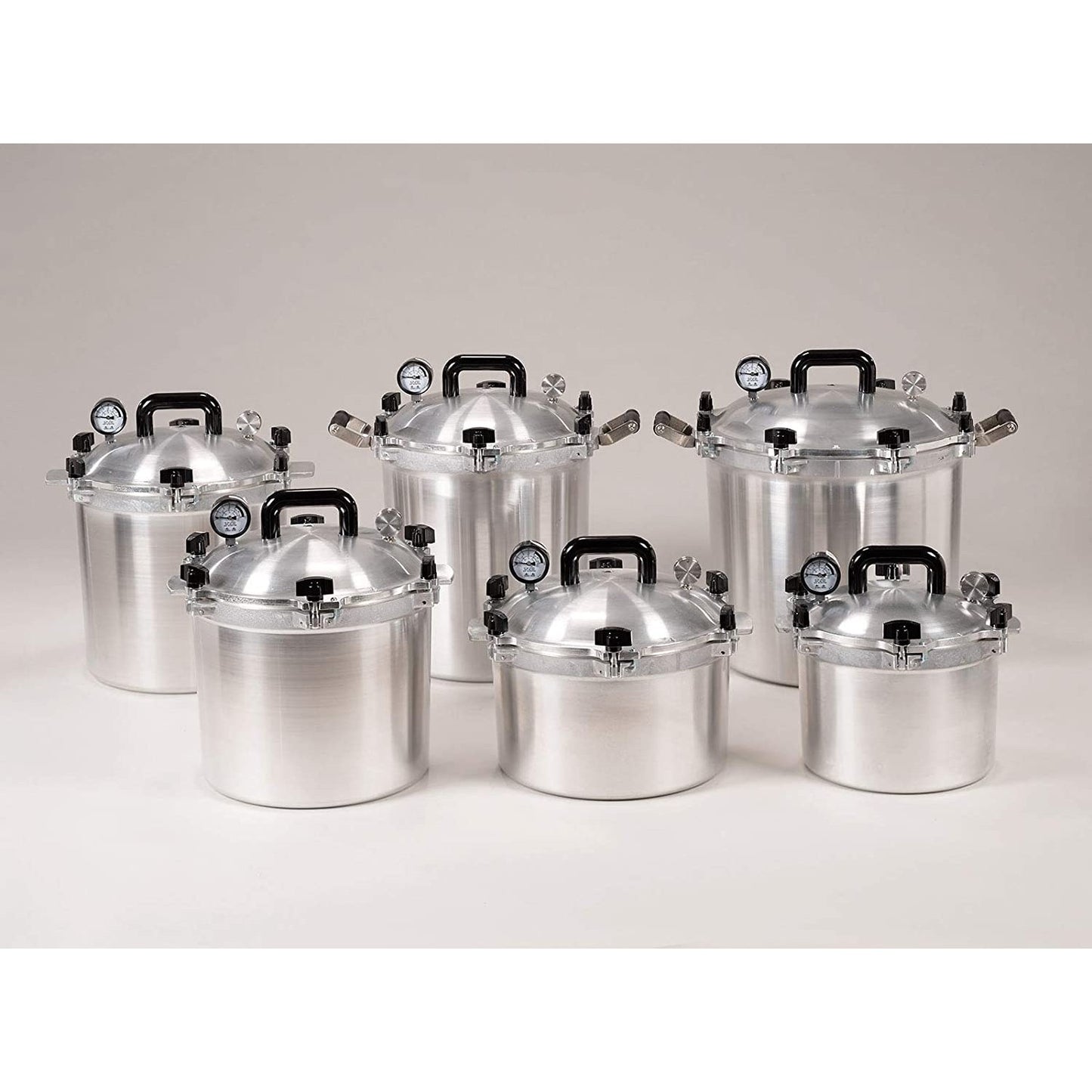 Collection of handcrafted heavy-duty aluminum pressure canners with black handles and built-in pressure gauges, perfect for safe food preservation in Farm, Garden & Tool and Kitchen & Food collections.