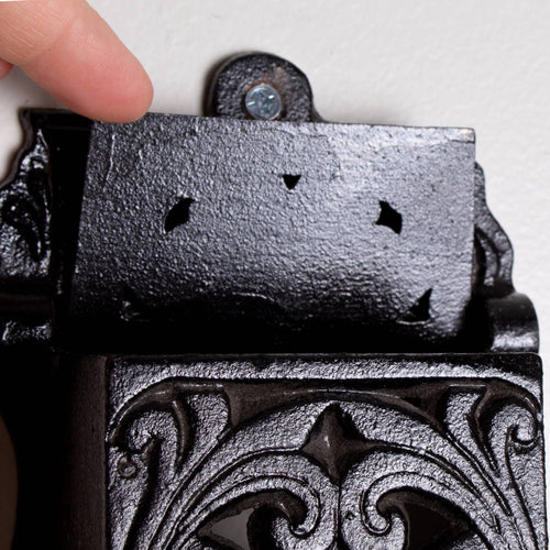 Handcrafted black metal wall-mounted matchbox holder with intricate vintage-inspired scrollwork, made in USA, perfect for Home & Decor, Household Helpers, and Lamps & Lighting collections.