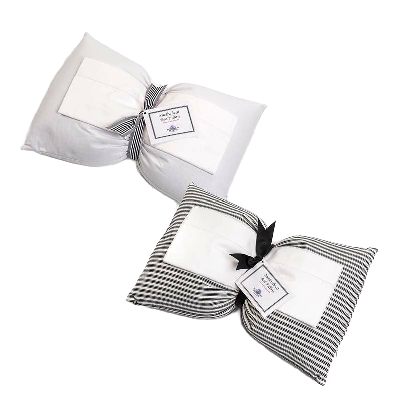 Two handcrafted buckwheat bed pillows, one solid white and one with gray and white stripes, tied with black ribbons and labels, part of Home & Decor and USA Made collections.